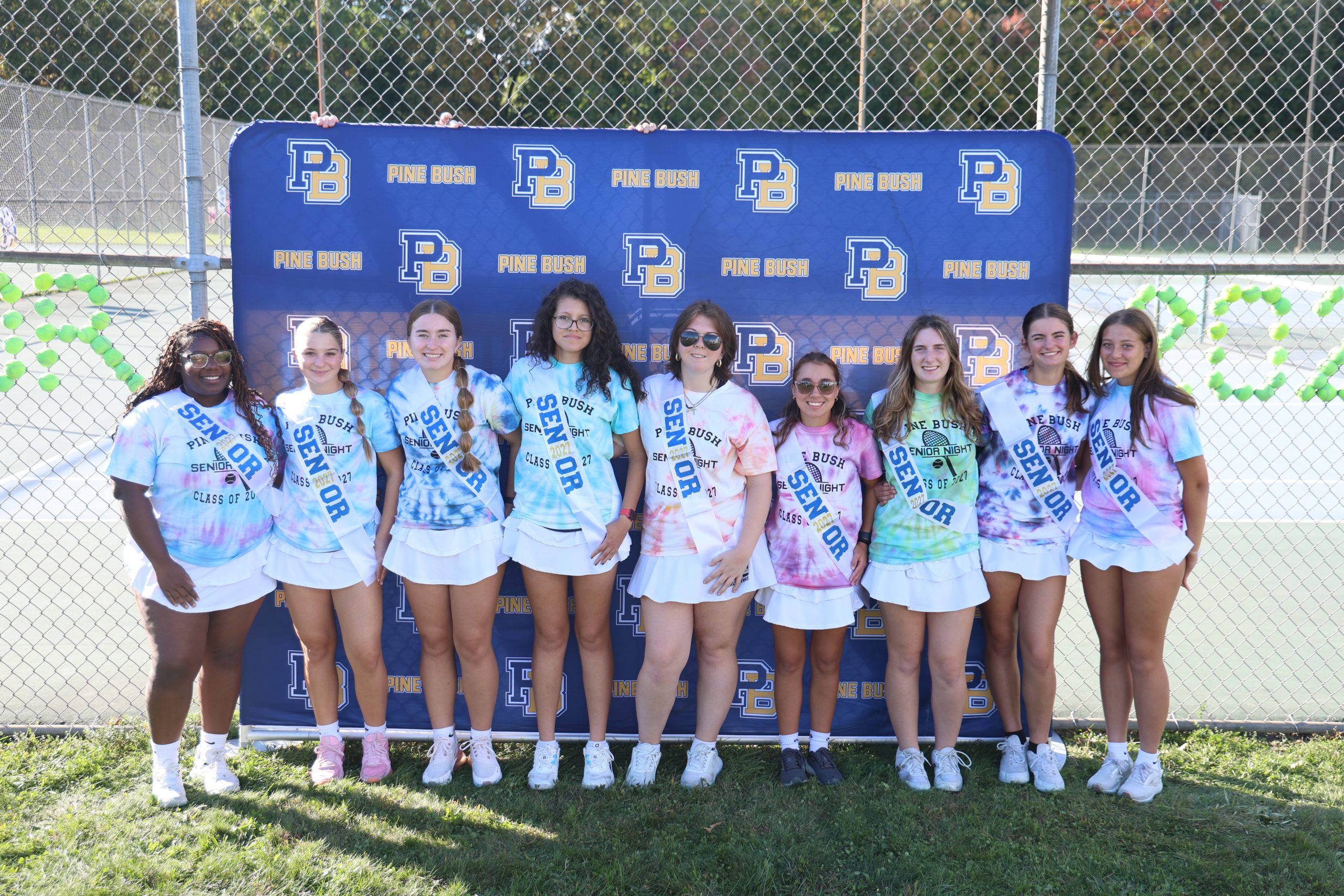 girls on tennis team standing for picture