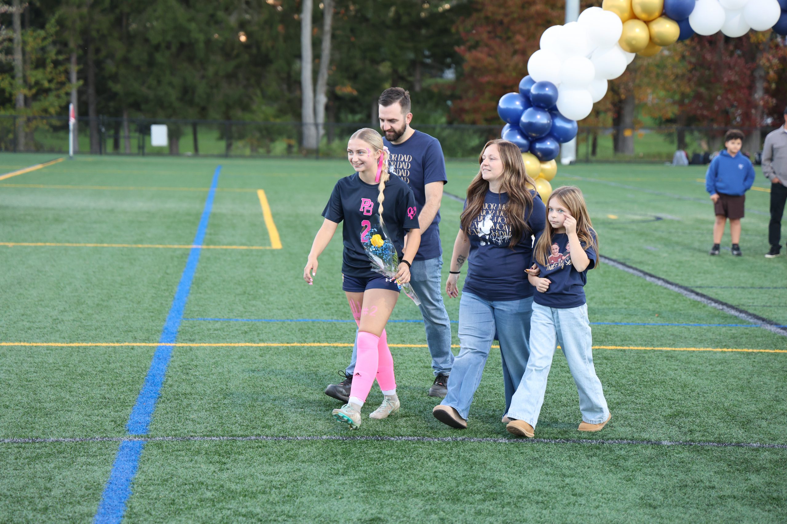 high school soccer player walking out with their parents