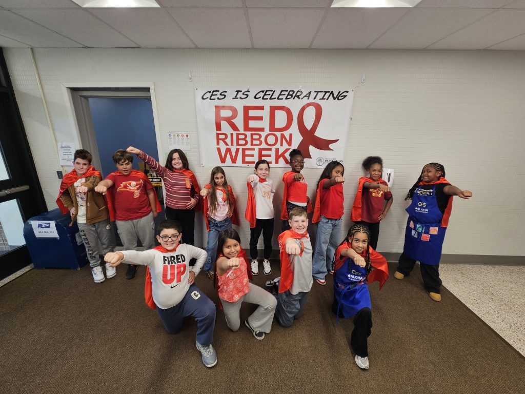 kids standing together wearing red shirts