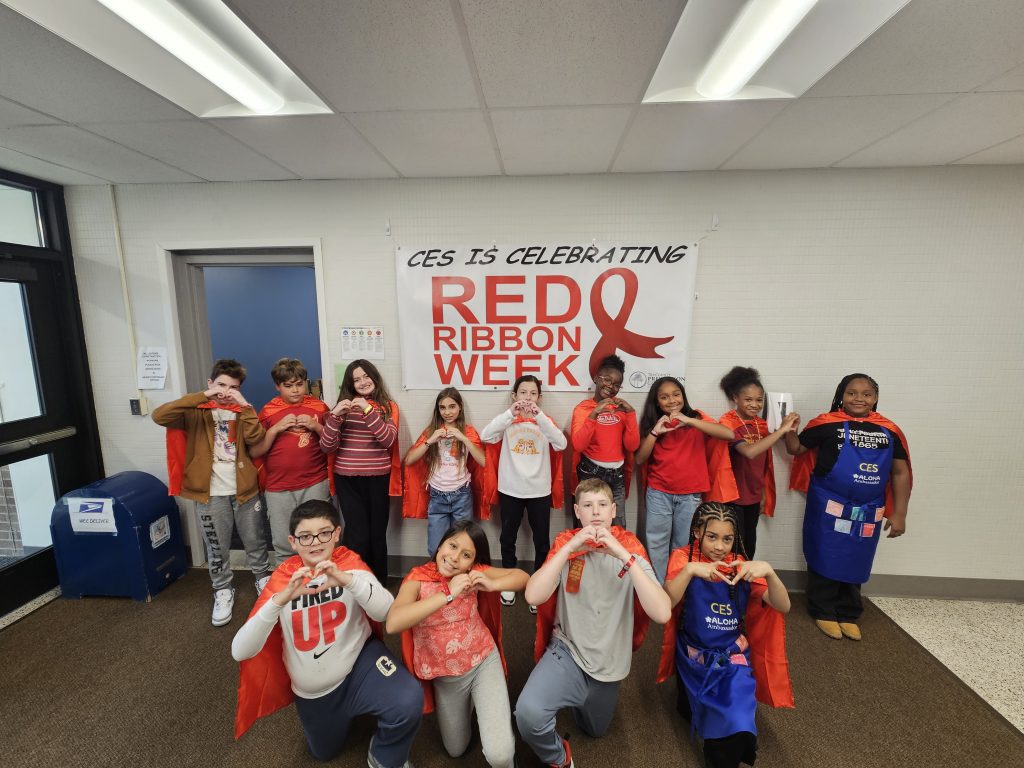 kids standing together wearing red shirts