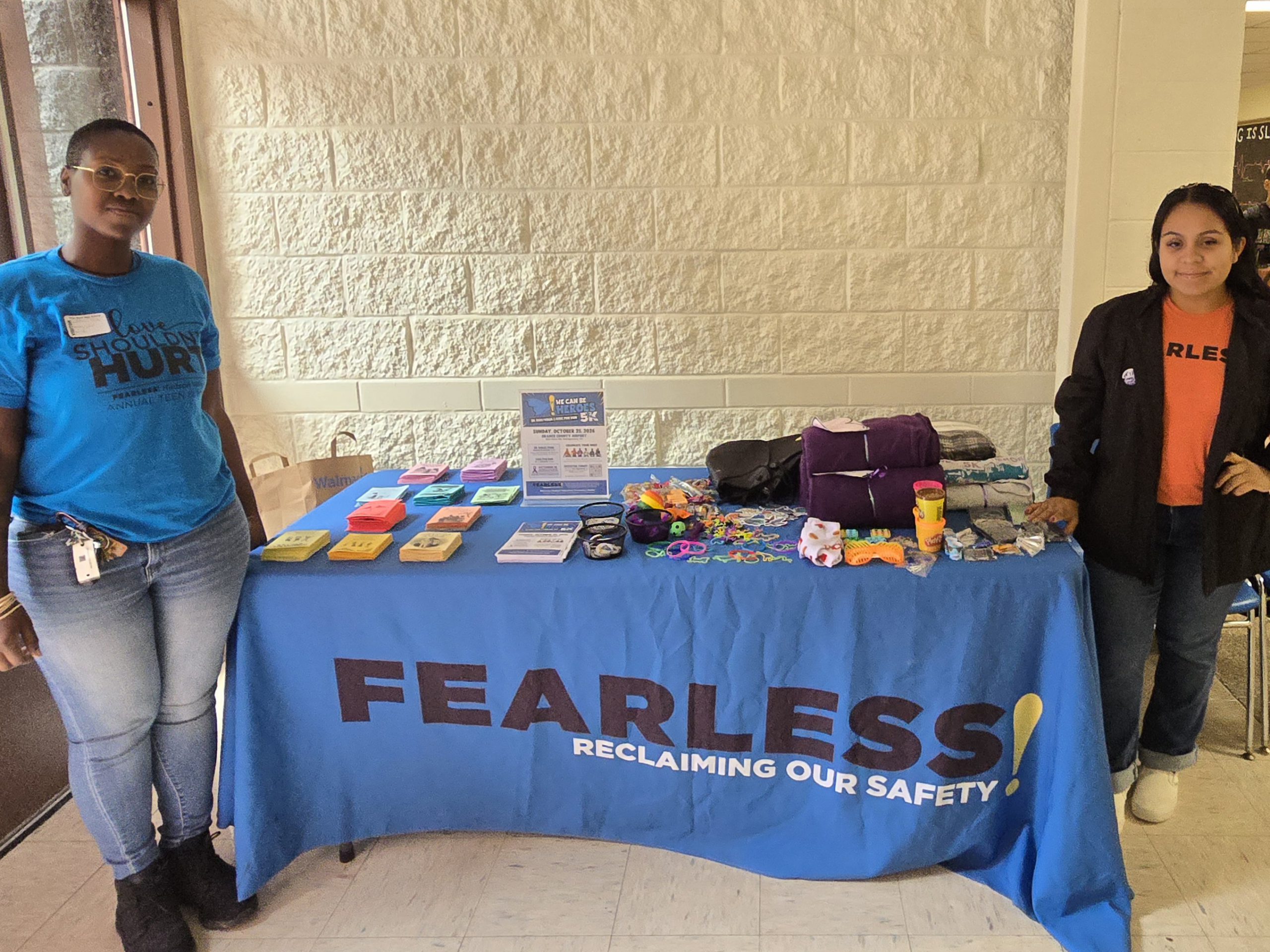 women standing near a table full of stuff