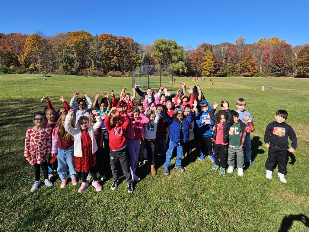 kids standing together wearing red shirts