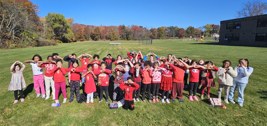 kids standing together wearing red shirts