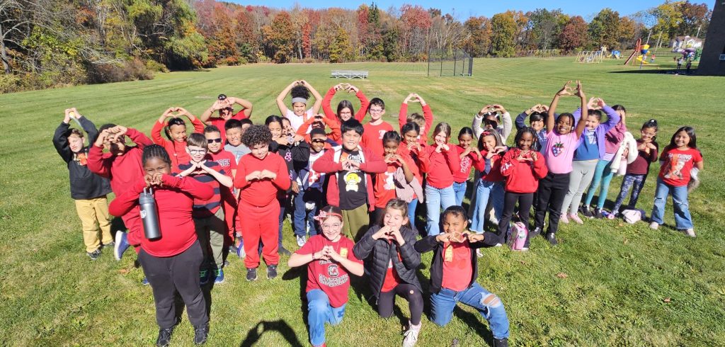 kids standing together wearing red shirts
