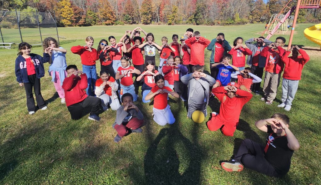 kids standing together wearing red shirts