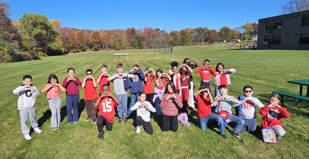 kids standing together wearing red shirts
