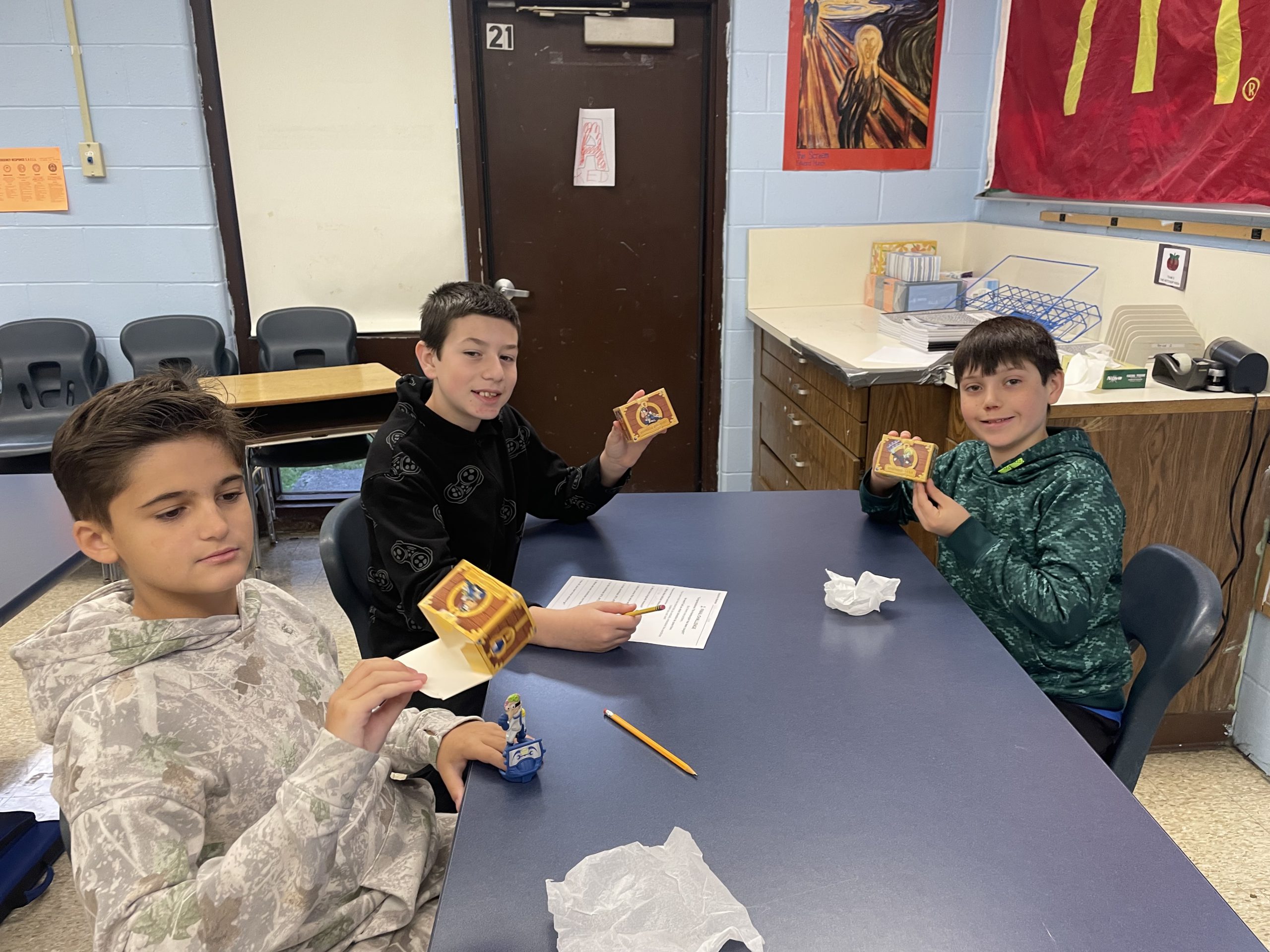 kids holding a small box with a toy