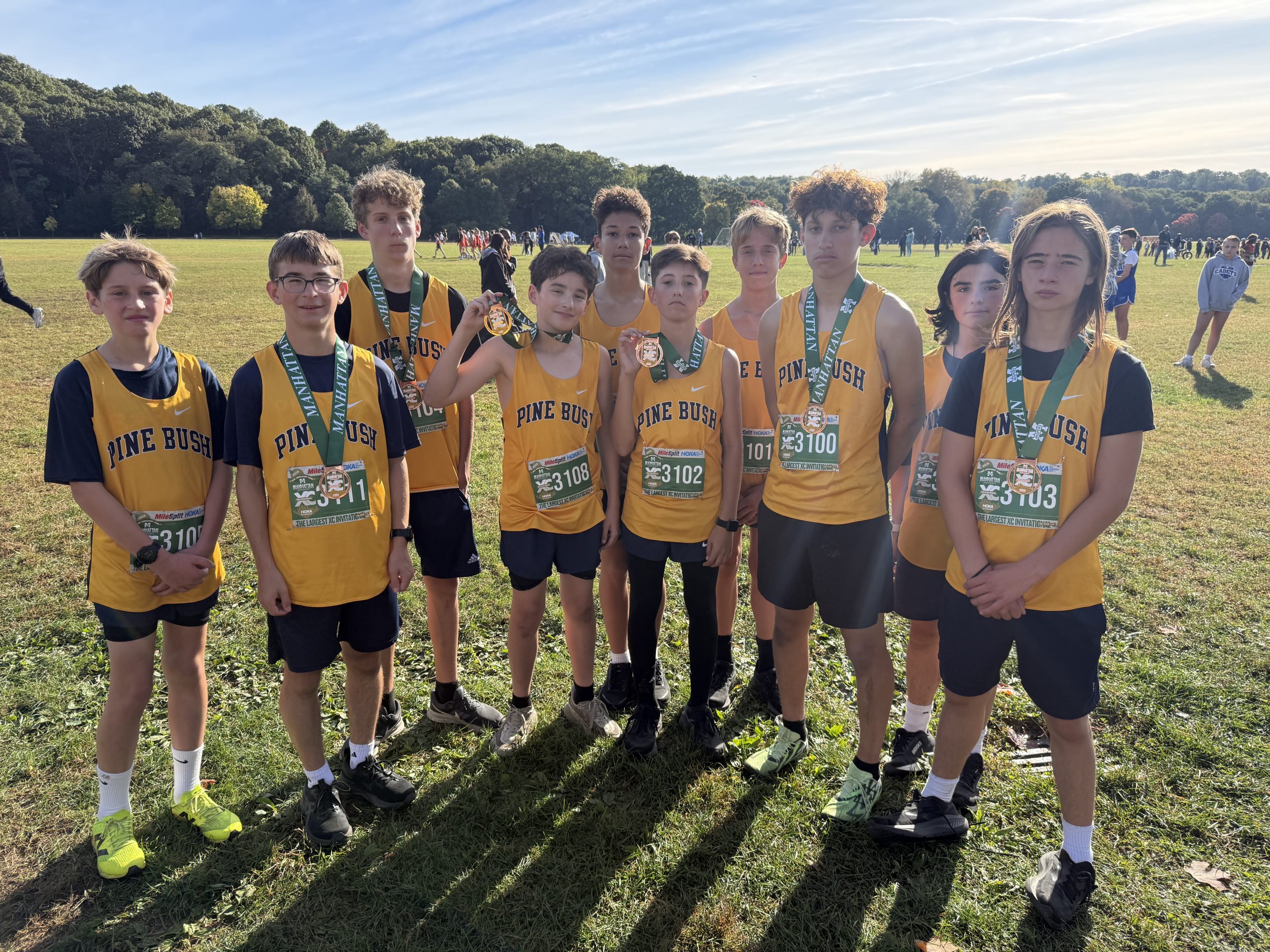 kids in track & field uniforms standing for picture