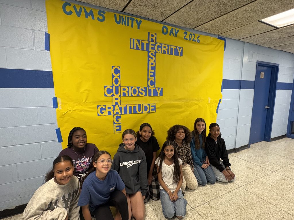 group of kids sitting on the ground 