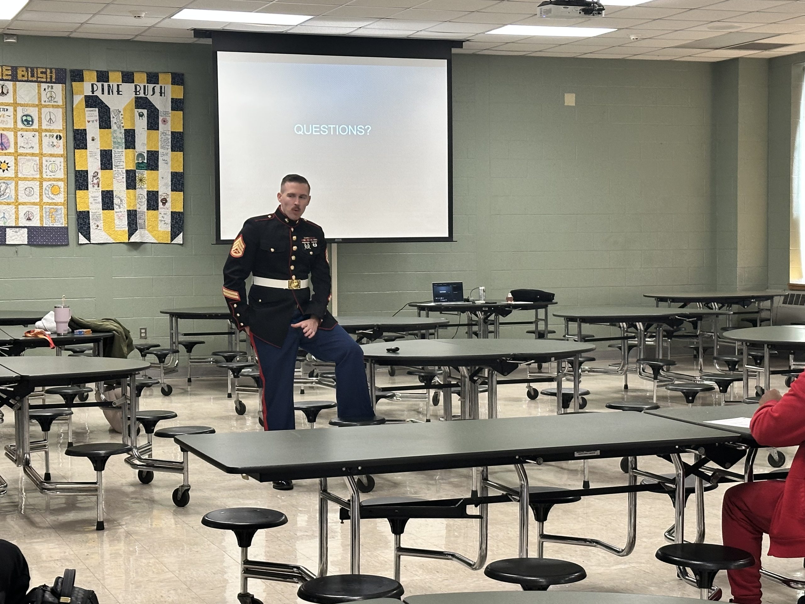 marine speaking to a group of students