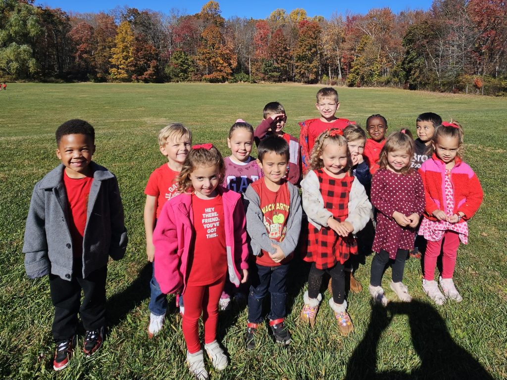 kids standing together wearing red shirts